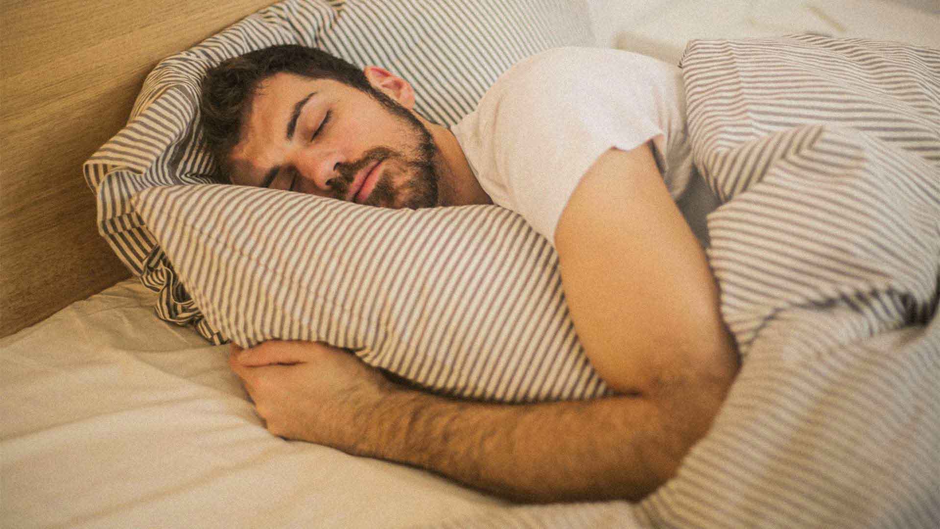 man sleeping in his bed