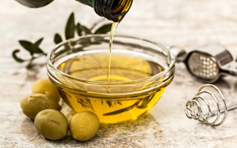 olive oil being poured into bowl