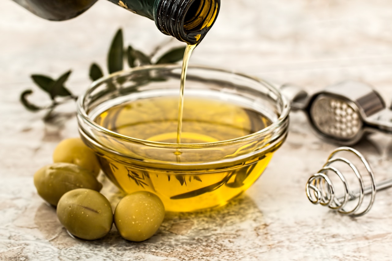 olive oil being poured into bowl