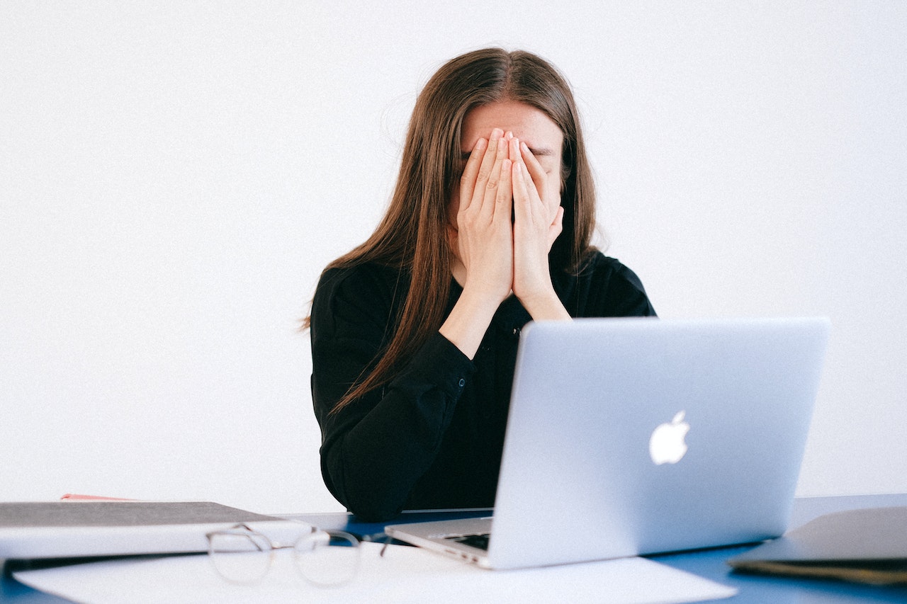 woman appearing stressed in front of computer