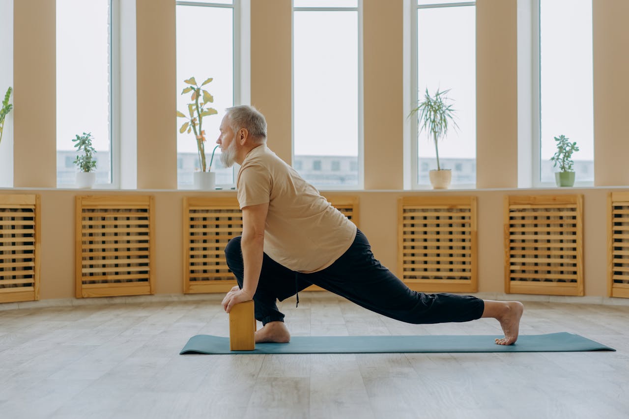 Man stretching with wooden blocks for joint flexibility and mobility
