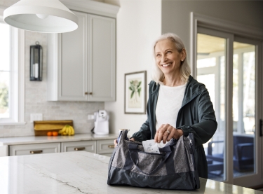 Woman smiling with vitamin packs